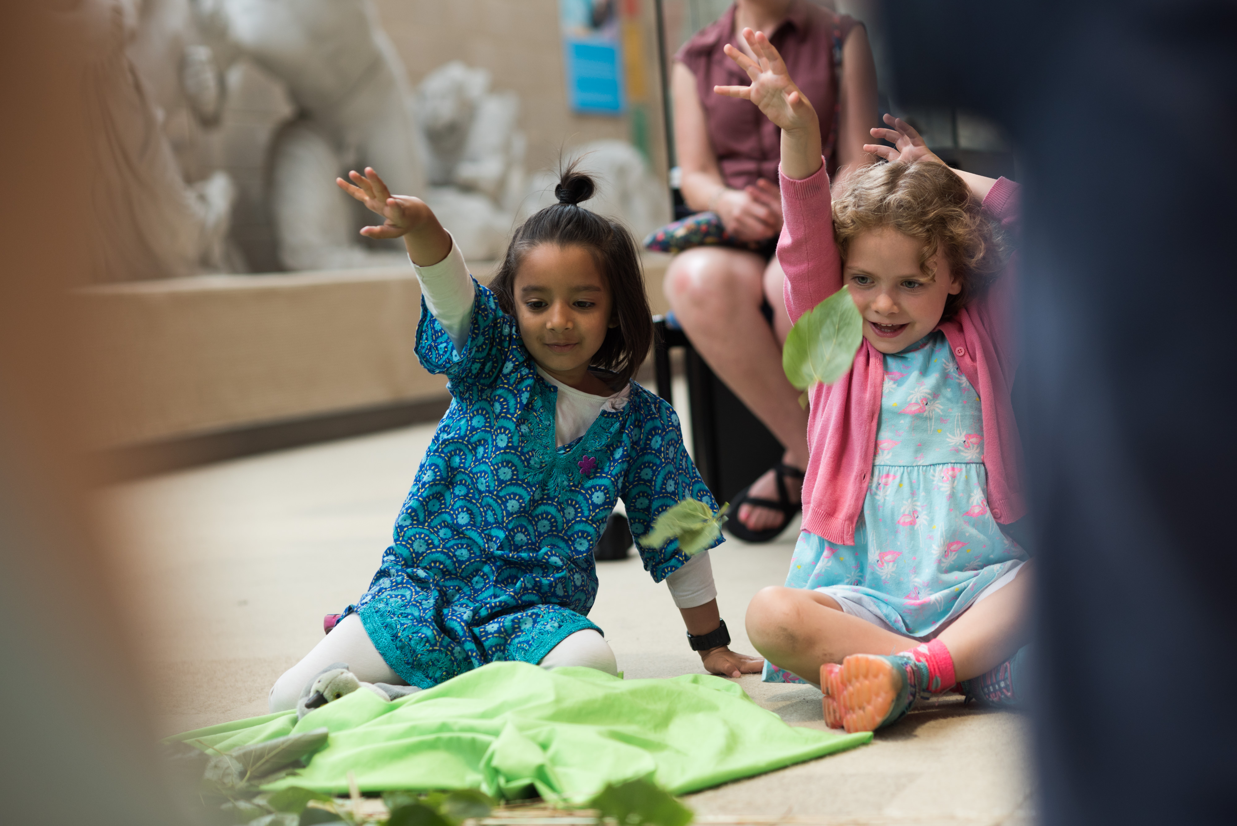 Children sitting on the ground in a museum gallery