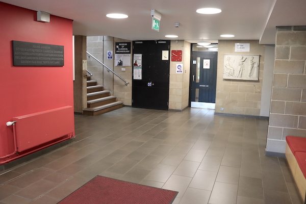 main foyer with tiled floor, seating and staircase access to Museum upstairs