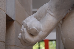 sculpted hands holding apples