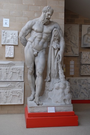 sculpture of naked Hercules, leaning on club with animal skin