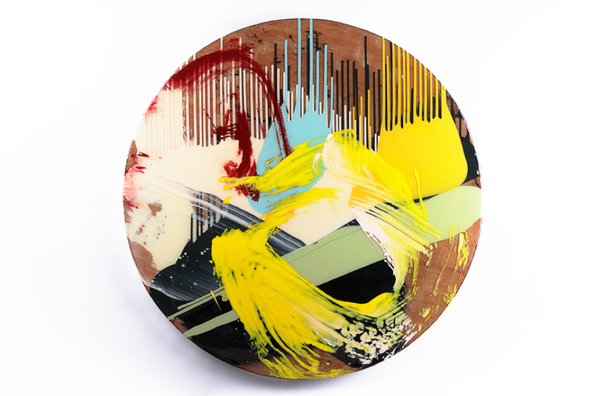 a circular abstract artwork with layers of coloured resin