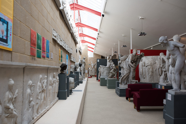 view of the gallery with wide carpeted throughways and natural lighting from above