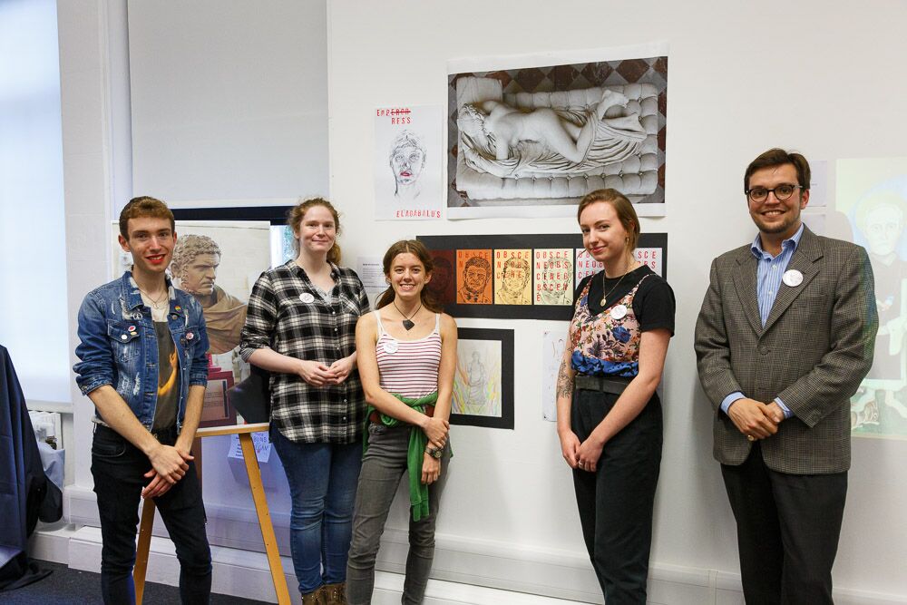 the museum remix team stand in front of their display