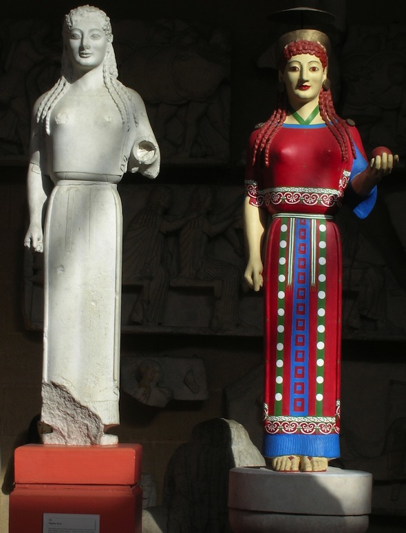 white unrestored cast of Peplos Kore next to version in red dress with blue and green details