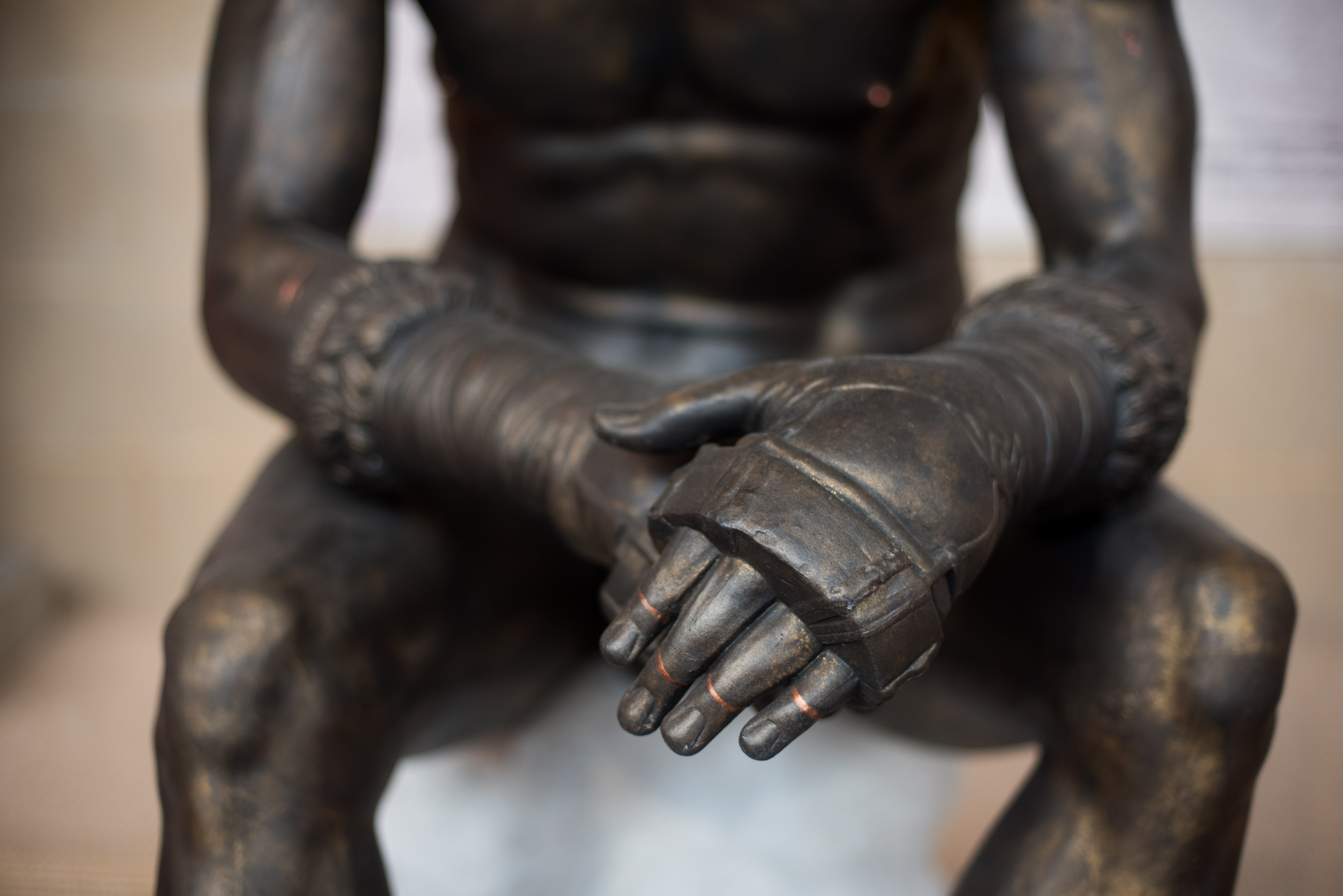 close up of Boxer's hands wearing fur-lined boxing gloves with metal knuckle guards