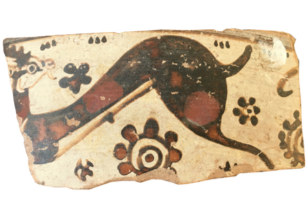 sherd of pottery with goat and flower pattern