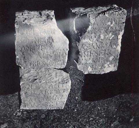 black and white photograph of a carved stone in two fragments