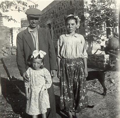 black and white photo of a local Turkish family, a man, woman and little girl with a bow in her hair