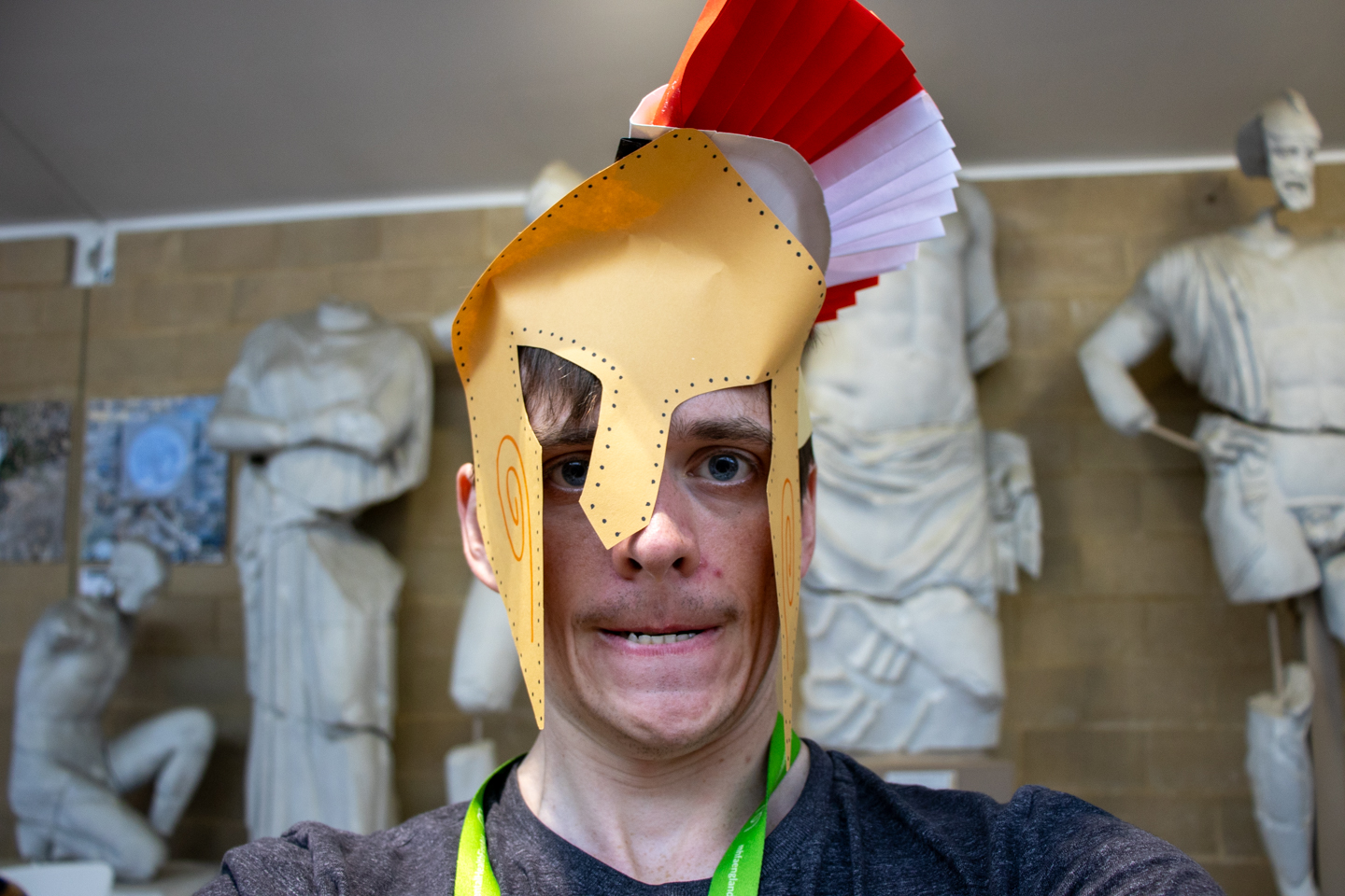Person making a scary face and wearing a handmade paper helmet