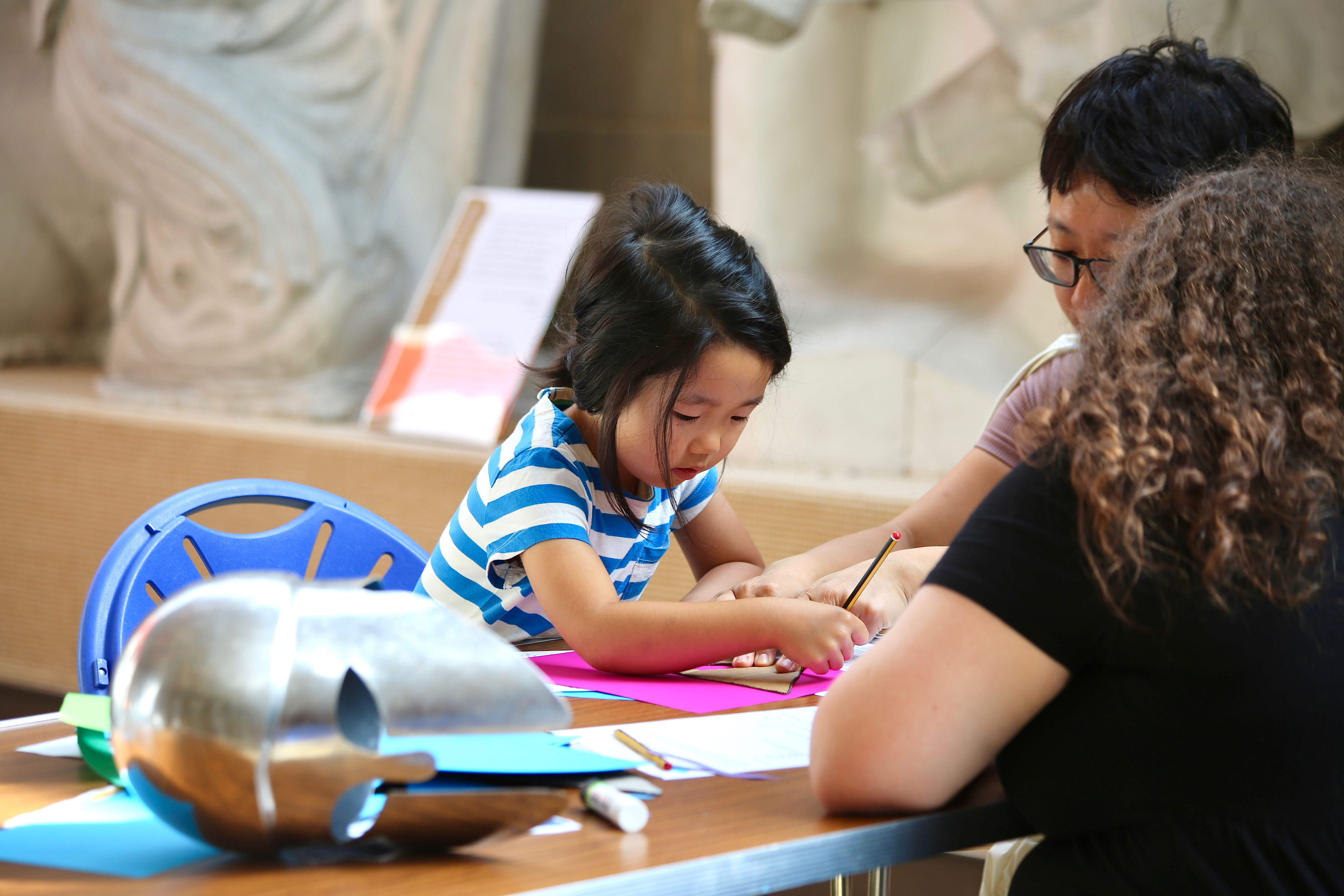 A parent a child doing a craft activity in the Museum of Classical Archaeology