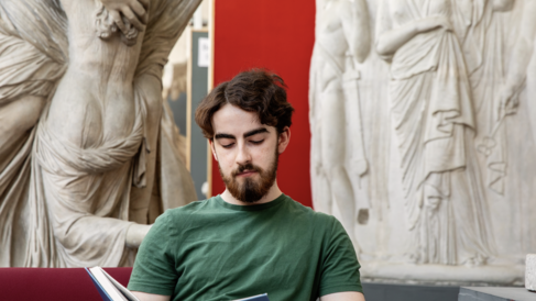 Undergraduate student reading in the Museum of Classical Archaeology