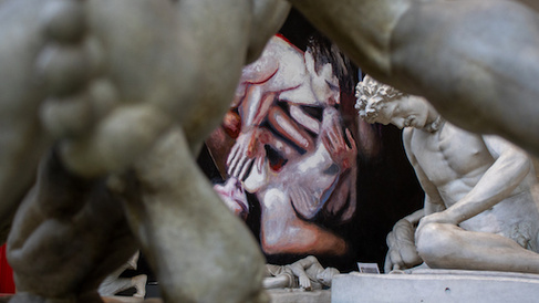 large painting of two naked men viewed through the limbs of a cast