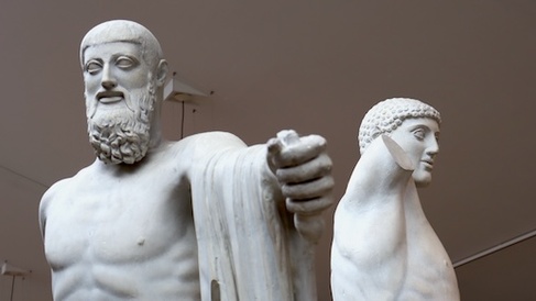statues of a bearded and unbearded pair advance on the viewer with swords