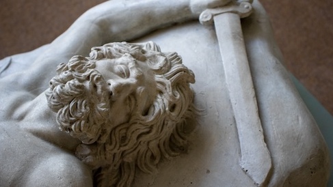 cast of bearded male figure lying down with sword above his head