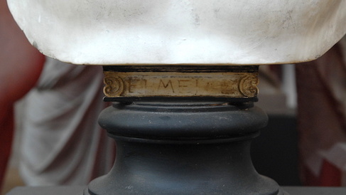 Base of a bust with degraded Greek letters in gold