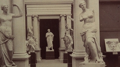 black and white photograph of plaster casts in old museum interior