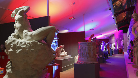 view of the Museum with bright pink and purple lights lighting up the statues