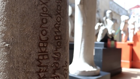 Inscribed text on side of a statue in a museum