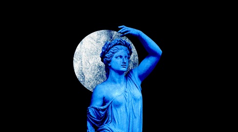 Ancient sculpture in blue holding the silver moon 