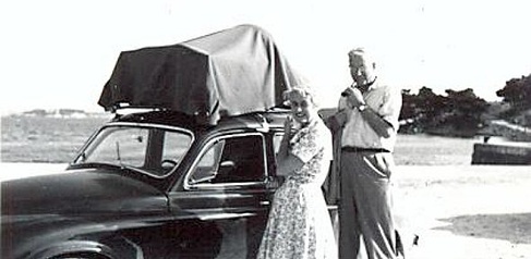 black and white photo of George Bean and his wife in front of a car