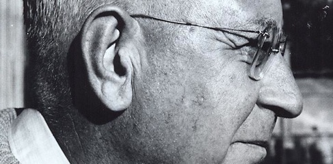 black and white photograph of a man with short white hair wearing glasses