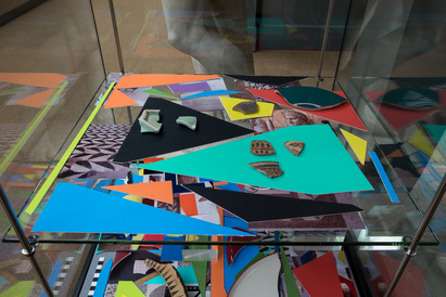 Multicoloured mountboard shapes, with ancient sherds on top