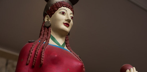 Painted face of the Peplos Kore, with red lips and eyes