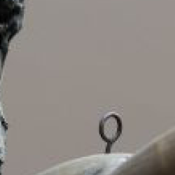 plaster cast of bronze Poseidon with a beard, standing with arms outstretched