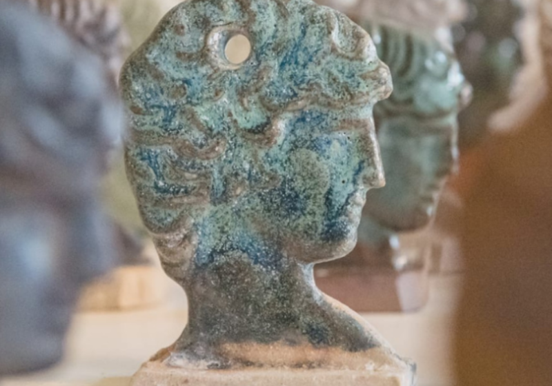 a queue of small glazed clay heads of Antinous