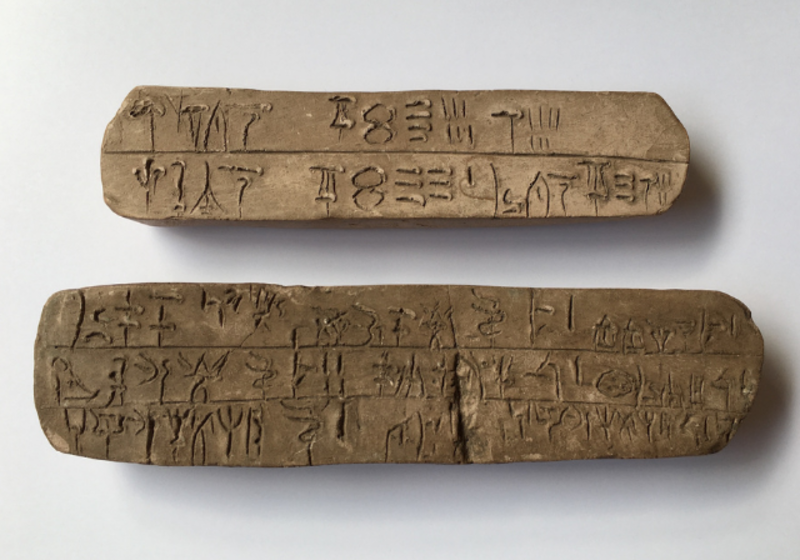 two tablets with writing inscribed in a syllabic script called Linear B