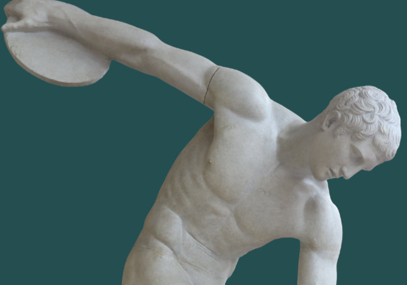 statue of a young naked man holding a discus ready to throw
