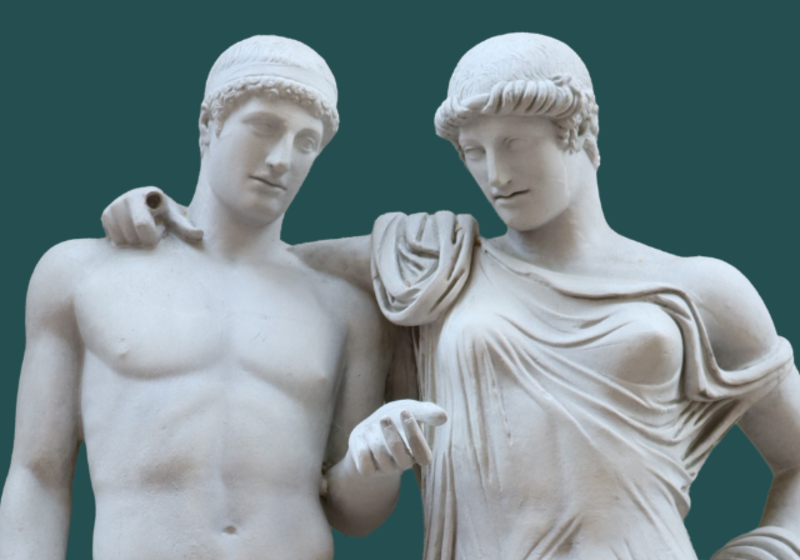 A statue of a clothed female figure with its arm around a naked youth