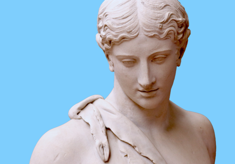 Statue of male god in deerskin against blue background