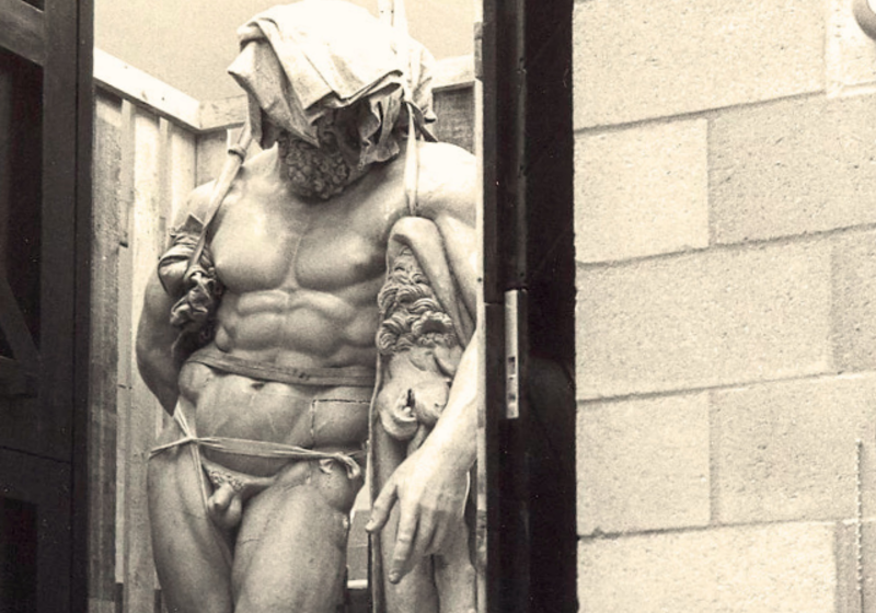 statue of Farnese Hercules with cloth on head, being moved into the museum of classical archaeology