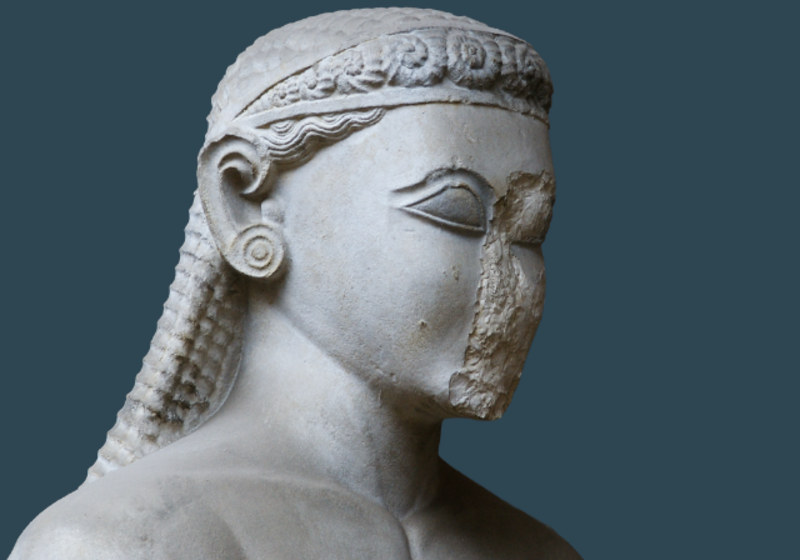 head of the sounion kouros, with long hair, decorative earring and broken nose, against a dark blue background