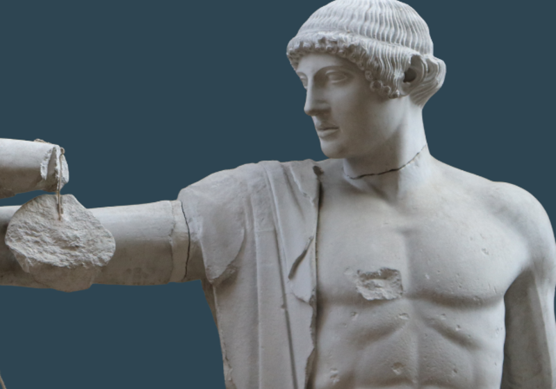 Figure of Apollo from the Temple of Zeus at Olympia, with short hair and a bare chest, against a dark blue background