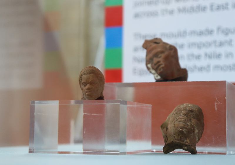 Three terracotta figurines (heads only) identified as figures with African origins