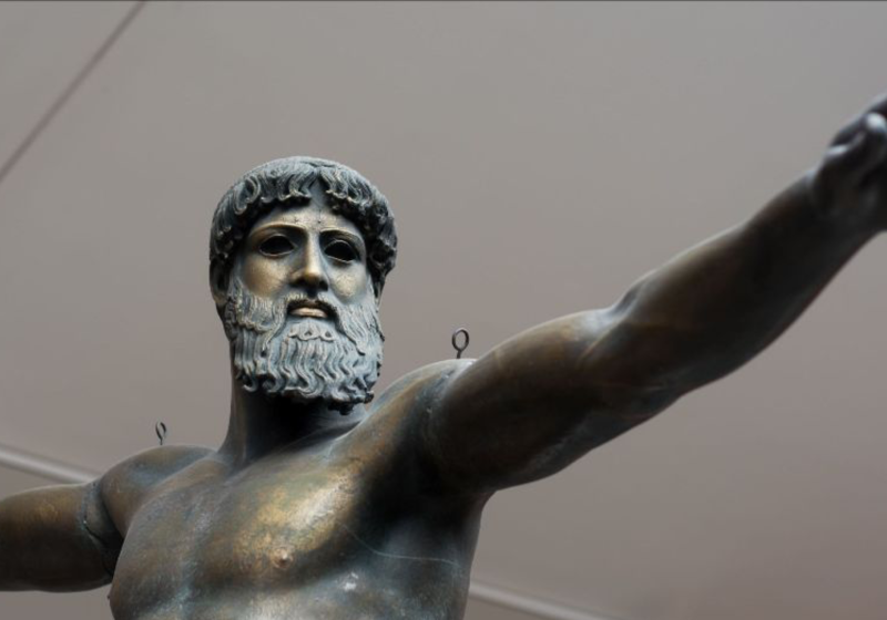 plaster cast of bronze Poseidon with a beard, standing with arms outstretched