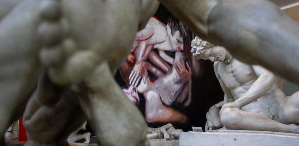 large painting of two naked men viewed through the limbs of a cast