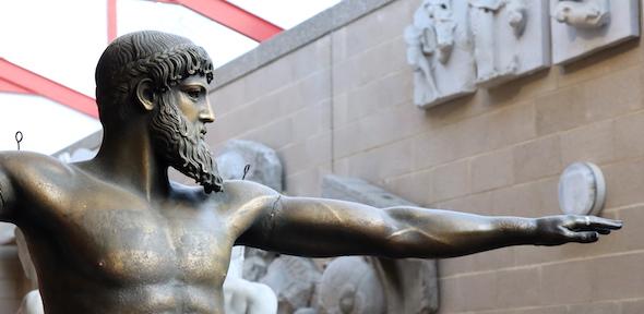 bronze statue with beard and outstretched arm