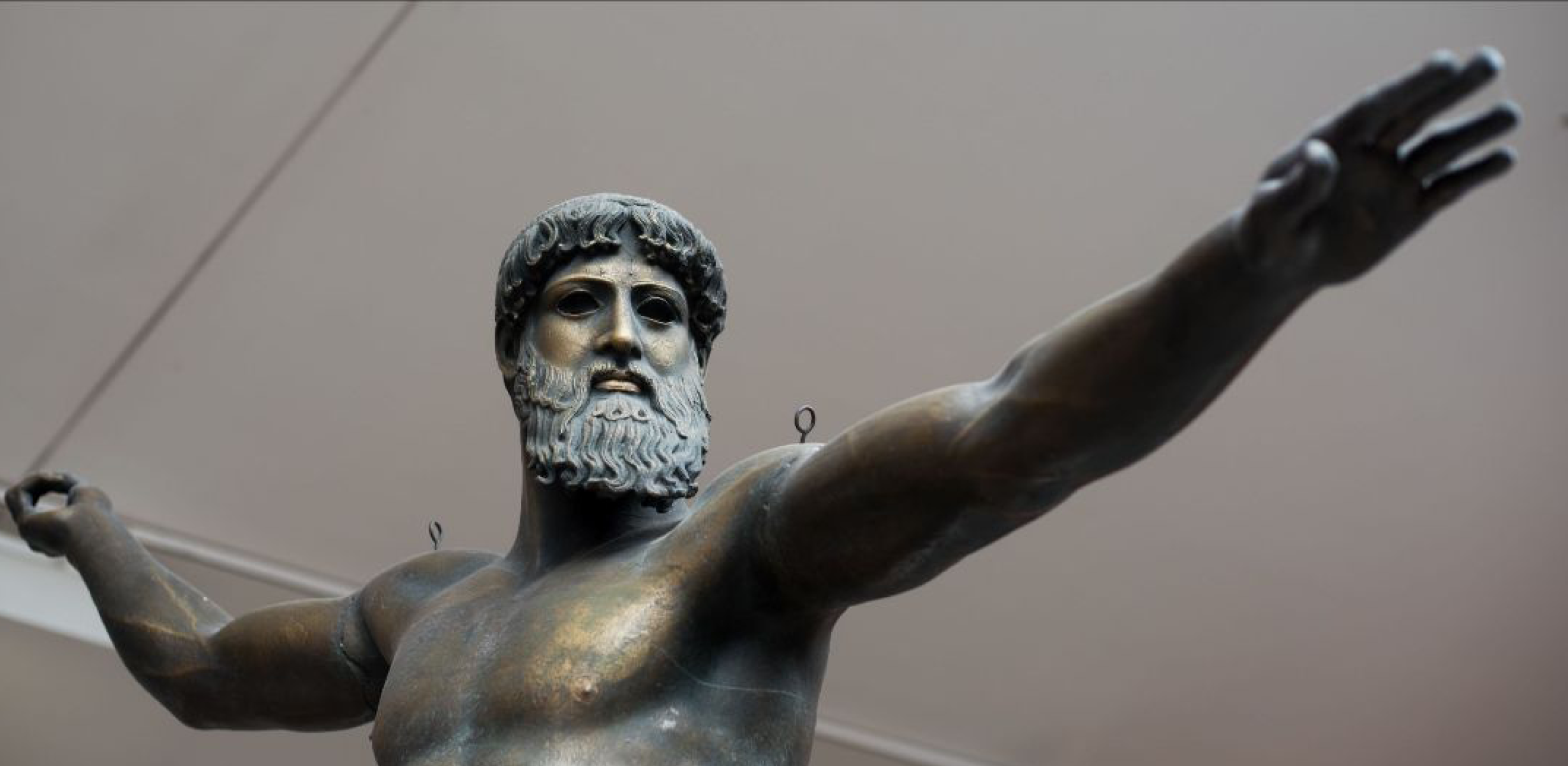 plaster cast of bronze Poseidon with a beard, standing with arms outstretched
