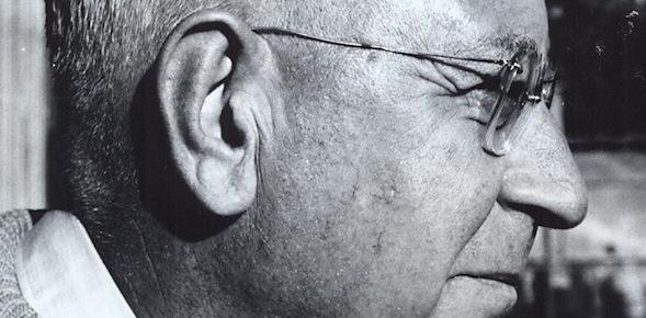 black and white photograph of a man with short white hair wearing glasses
