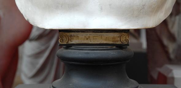 None Base of a bust with degraded Greek letters in gold