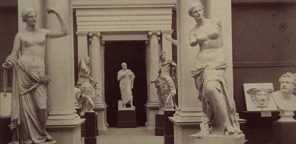 black and white photograph of plaster casts in old museum interior