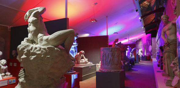 view of the Museum with bright pink and purple lights lighting up the statues