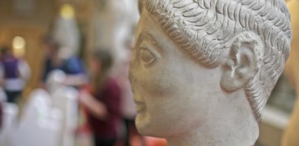 Archaic head with school children out of focus behind