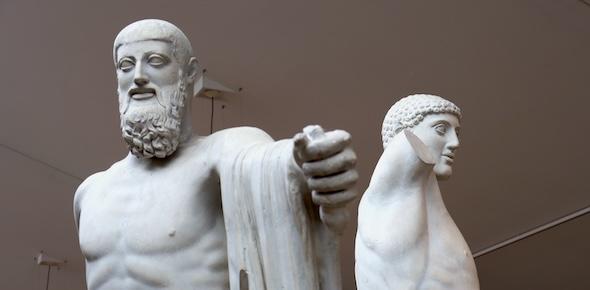 statues of a bearded and unbearded pair advance on the viewer with swords