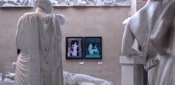 a view of two colourful lithographs between two statues. Marian Maguire, Goddesses, 2019