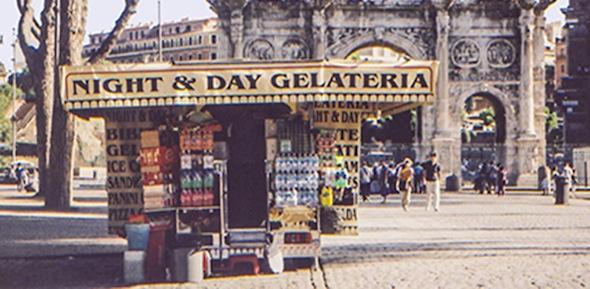 Colour photograph of a food stand in Rome, in front of the Arch of Constantine