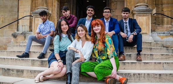 A group of Cambridge students seated on steps